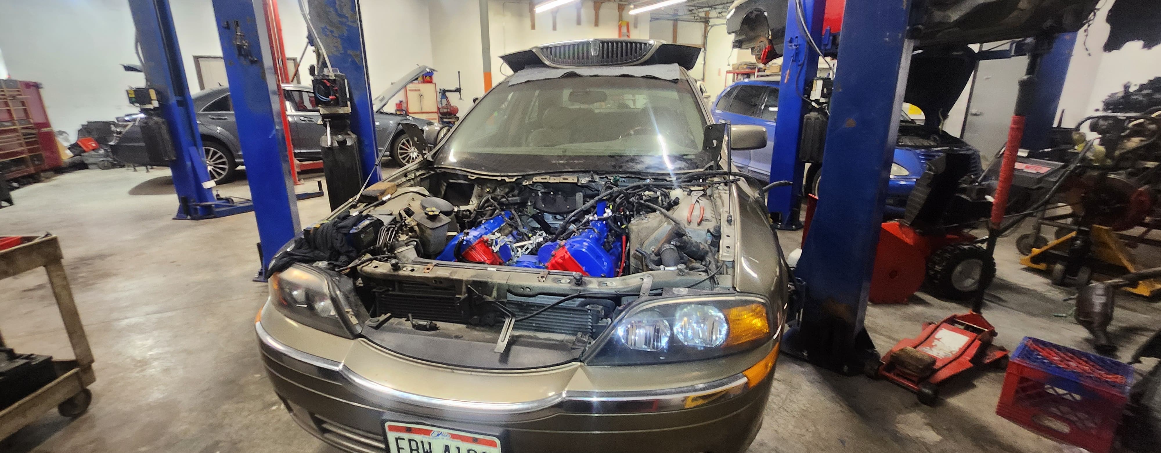 Vehicle with open hood under repair