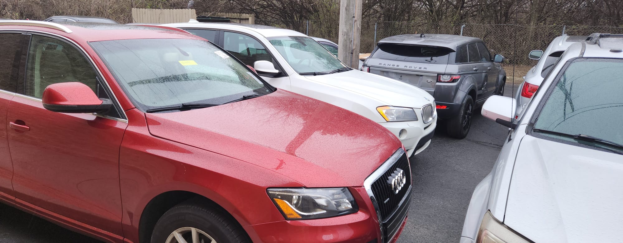 Vehicle lot with Audi, Range Rover, and BMW
